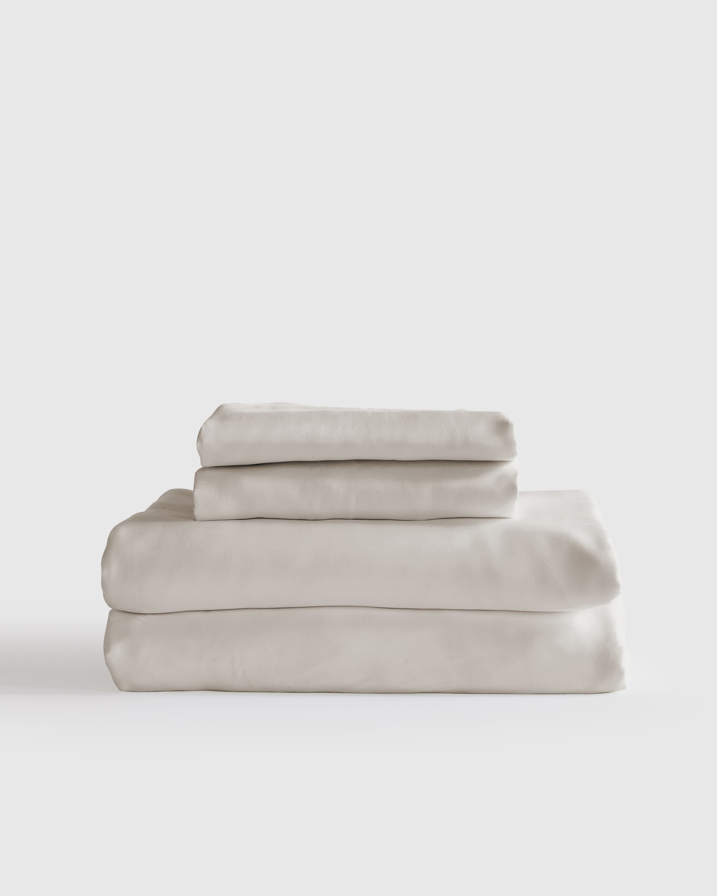 Quince organic bamboo viscose sheet set in sand color on bed
